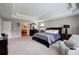 Spacious main bedroom with a large bed, soft carpet, and a view of the ensuite bathroom at 3015 Guardian Nw Walk, Kennesaw, GA 30152