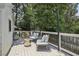 Outdoor living space features an inviting back deck with seating, decorative lighting and wooded view at 502 Hascall Nw Rd, Atlanta, GA 30309