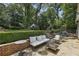 Beautifully landscaped backyard with multiple seating areas, lush plantings, and a charming storage shed at 502 Hascall Nw Rd, Atlanta, GA 30309