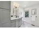 Bright bathroom with a gray vanity cabinet, marble countertop, and hexagon tile floors at 502 Hascall Nw Rd, Atlanta, GA 30309