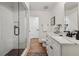 Modern bathroom featuring a glass shower, white vanity, and white subway tile at 502 Hascall Nw Rd, Atlanta, GA 30309