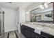 Elegant bathroom featuring double sinks, marble countertops, and a glass-enclosed shower at 502 Hascall Nw Rd, Atlanta, GA 30309