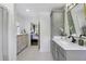Bright bathroom with a gray vanity cabinet, marble countertop, and hexagon tile floors at 502 Hascall Nw Rd, Atlanta, GA 30309