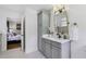 Bright bathroom with a gray vanity cabinet, marble countertop, and decorative light fixture at 502 Hascall Nw Rd, Atlanta, GA 30309