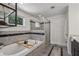 Stylish bathroom with a standalone tub, walk-in shower, and elegant tile accents at 502 Hascall Nw Rd, Atlanta, GA 30309