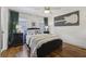 Comfortable bedroom featuring hardwood floors, a ceiling fan and decorous wall art at 502 Hascall Nw Rd, Atlanta, GA 30309