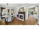Bright dining room featuring a decorative fireplace, hardwood floors, and elegant chandelier at 502 Hascall Nw Rd, Atlanta, GA 30309