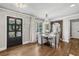Cozy dining room with hardwood floors, a decorative mirror, and large windows for natural light at 502 Hascall Nw Rd, Atlanta, GA 30309