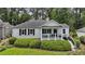 Charming white-brick home with black shutters, inviting front porch, and beautifully landscaped front yard at 502 Hascall Nw Rd, Atlanta, GA 30309