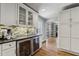 Kitchen with stainless steel beverage cooler, mosaic backsplash, and view into dining room at 502 Hascall Nw Rd, Atlanta, GA 30309