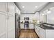 Bright kitchen featuring stainless steel appliances, granite countertops and white cabinets at 502 Hascall Nw Rd, Atlanta, GA 30309