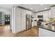 Bright kitchen featuring stainless steel appliances, granite countertops and white cabinets at 502 Hascall Nw Rd, Atlanta, GA 30309