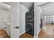Hallway with a laundry area with stacked washer and dryer, hardwood flooring and neutral paint at 502 Hascall Nw Rd, Atlanta, GA 30309