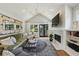 Cozy living room featuring a brick fireplace, built-in shelving, and large windows at 502 Hascall Nw Rd, Atlanta, GA 30309
