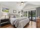 Bright main bedroom with hardwood floors, a ceiling fan, and access to the backyard at 502 Hascall Nw Rd, Atlanta, GA 30309