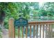 View of a tranquil pond with a Certified Wildlife Habitat sign on a wooden fence at 502 Hascall Nw Rd, Atlanta, GA 30309