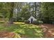 Storage shed surrounded by manicured landscaping providing ample storage and complements the serene backyard at 502 Hascall Nw Rd, Atlanta, GA 30309
