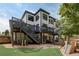 Spacious backyard featuring a two-story deck, playground and outdoor living area at 2295 Abbey Cove Ct, Marietta, GA 30062