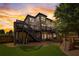 A cozy backyard space with a lush lawn, tiered deck, and a playset at 2295 Abbey Cove Ct, Marietta, GA 30062