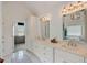 Bright bathroom with double sinks, white cabinets, marble counters and floors at 2295 Abbey Cove Ct, Marietta, GA 30062