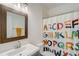 Modern bathroom with a playful shower curtain, vanity, and clean lines at 2295 Abbey Cove Ct, Marietta, GA 30062