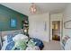 Comfortable bedroom showcasing a vibrant accent wall, unique shelving, and charming details at 2295 Abbey Cove Ct, Marietta, GA 30062