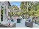 Relaxing outdoor deck with comfortable lounge chairs, a fire pit, and decorative string lights at 2295 Abbey Cove Ct, Marietta, GA 30062