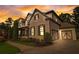 Elegant home with a painted brick exterior, well-manicured lawn, and inviting curb appeal at sunset at 2295 Abbey Cove Ct, Marietta, GA 30062