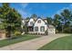Gorgeous two-story home showcasing a lush green lawn, driveway, and painted brick exterior with dark shutters at 2295 Abbey Cove Ct, Marietta, GA 30062