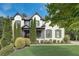 Beautiful two-story home with a well-maintained lawn, mature trees, and a classic painted brick facade at 2295 Abbey Cove Ct, Marietta, GA 30062
