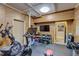 Well-equipped home gym with wood paneled walls, cardio machines, free weights, and entertainment system at 2295 Abbey Cove Ct, Marietta, GA 30062
