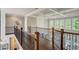 Open hallway with coffered ceiling, hardwood floors, and wrought iron banister at 2295 Abbey Cove Ct, Marietta, GA 30062