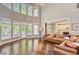 Spacious living room with soaring ceilings, large windows, and a comfortable leather sofa at 2295 Abbey Cove Ct, Marietta, GA 30062