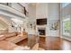 Comfortable living room features built-in shelves, a stone fireplace, and a large television at 2295 Abbey Cove Ct, Marietta, GA 30062