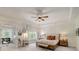 Spacious main bedroom with a ceiling fan, ensuite seating area, and natural light at 2295 Abbey Cove Ct, Marietta, GA 30062