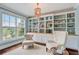 Bright study features custom built-in shelves, stylish lighting, and a cozy seating area at 2295 Abbey Cove Ct, Marietta, GA 30062