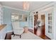 Cozy study with elegant light fixture, built-in shelves, and French doors leading to the foyer at 2295 Abbey Cove Ct, Marietta, GA 30062
