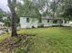 Backyard view of the home with mature shade trees at 4125 N Dearing Ne St, Covington, GA 30014