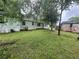 The backyard of the home has mature trees and grass at 4125 N Dearing Ne St, Covington, GA 30014