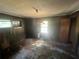 Interior bedroom view with natural light and damaged wooden floor at 4125 N Dearing Ne St, Covington, GA 30014