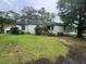 Quaint single-story home with light green siding and mature trees at 4125 N Dearing Ne St, Covington, GA 30014