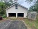 A two-car detached garage with a weathered exterior shows its two open bays and a small window above at 4125 N Dearing Ne St, Covington, GA 30014