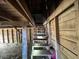 The wooden staircase in the garage interior leads to an upper level with exposed wood and weathered walls at 4125 N Dearing Ne St, Covington, GA 30014