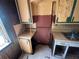 Close-up of a kitchen featuring aged cabinets, countertops, and a window for natural light at 4125 N Dearing Ne St, Covington, GA 30014