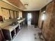Spacious kitchen with a double sink, wooden cabinets, and access to other rooms at 4125 N Dearing Ne St, Covington, GA 30014