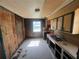 A vintage kitchen featuring outdated cabinetry, flooring damage, and a double sink setup at 4125 N Dearing Ne St, Covington, GA 30014