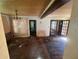 An empty living room featuring dark wood floors, an outdated light fixture, and peeling paint at 4125 N Dearing Ne St, Covington, GA 30014