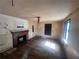 Living room featuring a brick fireplace, hardwood floors, and large window with natural light at 4125 N Dearing Ne St, Covington, GA 30014