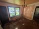 A living room showcasing peeling walls, a window, and an outdated chandelier at 4125 N Dearing Ne St, Covington, GA 30014
