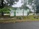 The side of the home with access to the crawlspace and some shrubbery at 4125 N Dearing Ne St, Covington, GA 30014